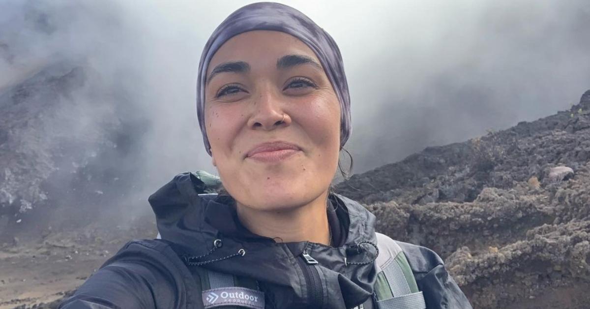 Hannah Kobayashi smiles on top of a mountain