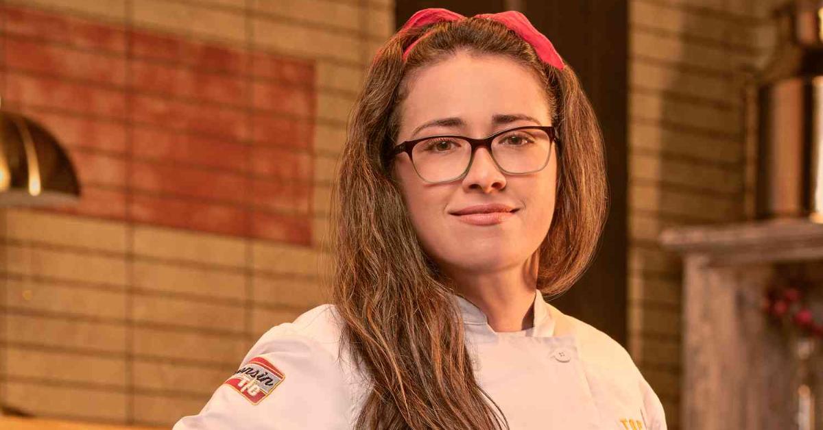 Alisha Elenz wears a white chef's jacket for her official portrait for 'Top Chef: Wisconsin.'