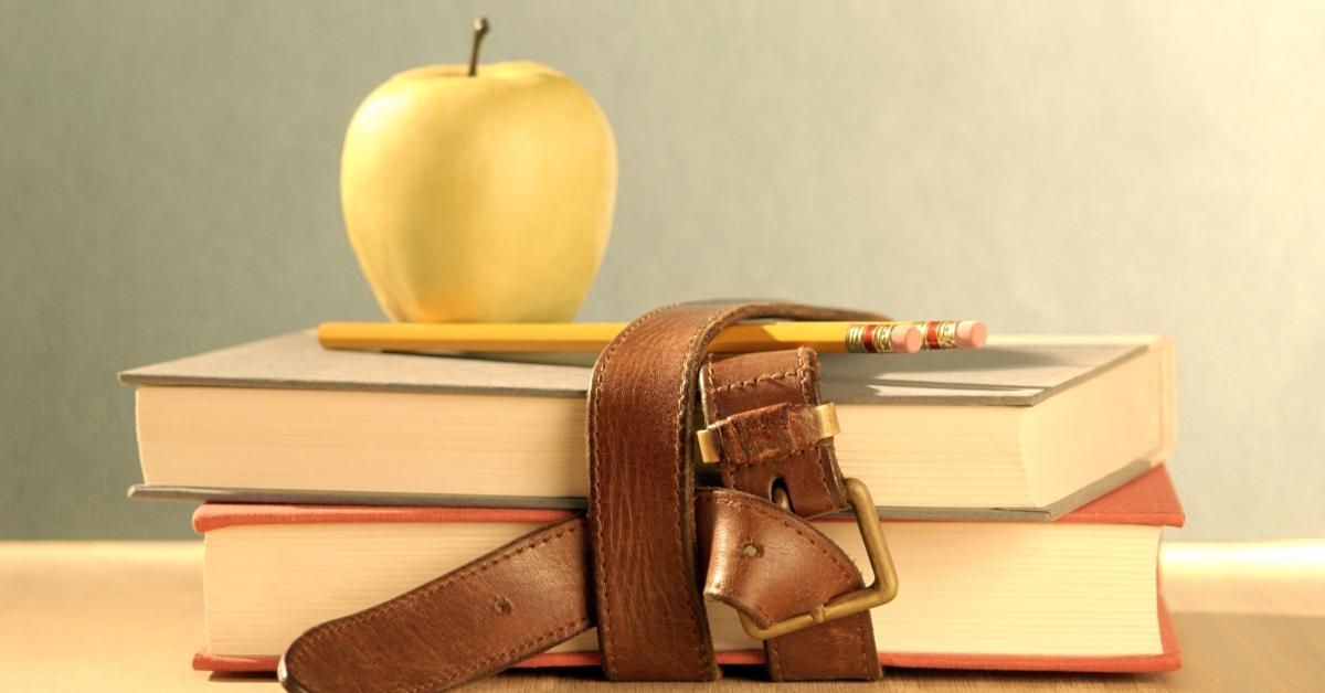 books and apple on teacher's desk