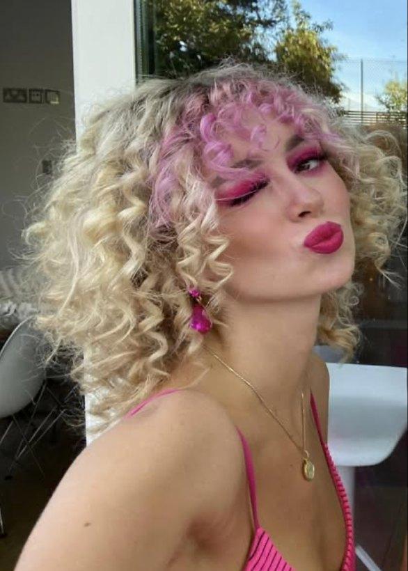 Kate Shemirani's daughter Paloma with pink curly hair.