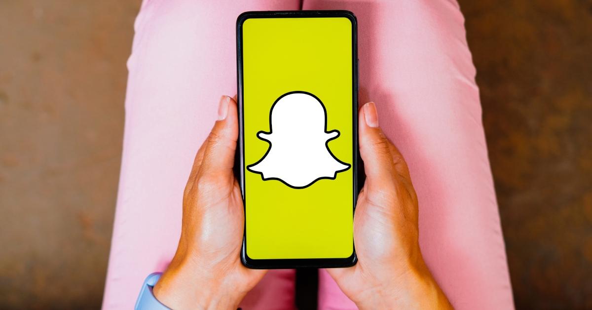 Snapchat logo is displayed on a smartphone screen.