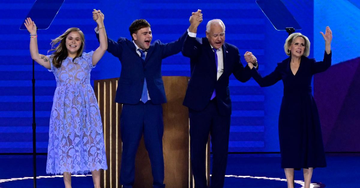 Tim Walz and his family raise their hands and celebrate at the 2024 DNC.