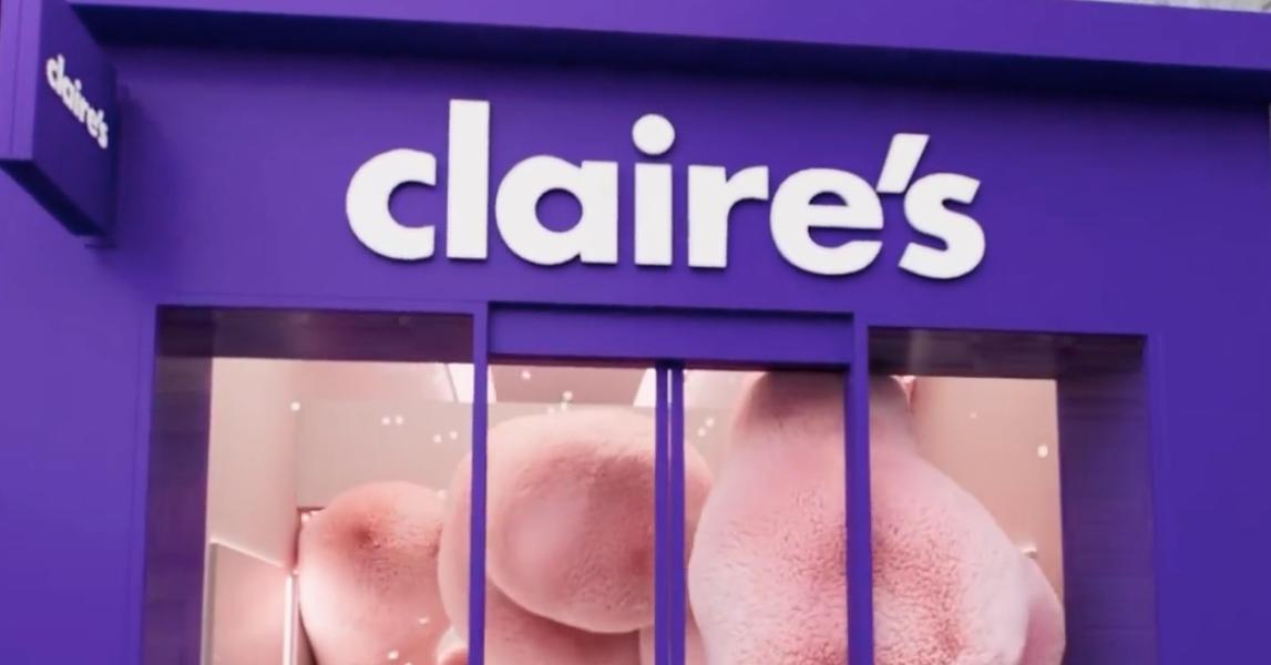 Purple Claire's storefront with furry pink animation inside of store.