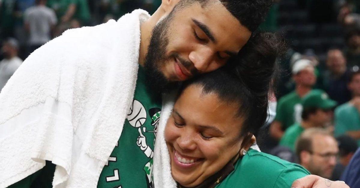 Jayson Tatum and his mom on the court, hugging and smiling