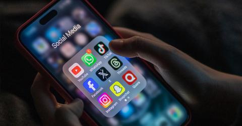 Social media icons, including Snapchat, on a smartphone