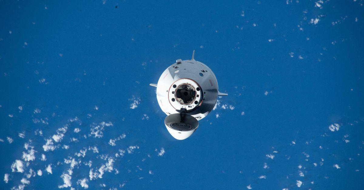The Dragon Spacecraft floating above Earth.