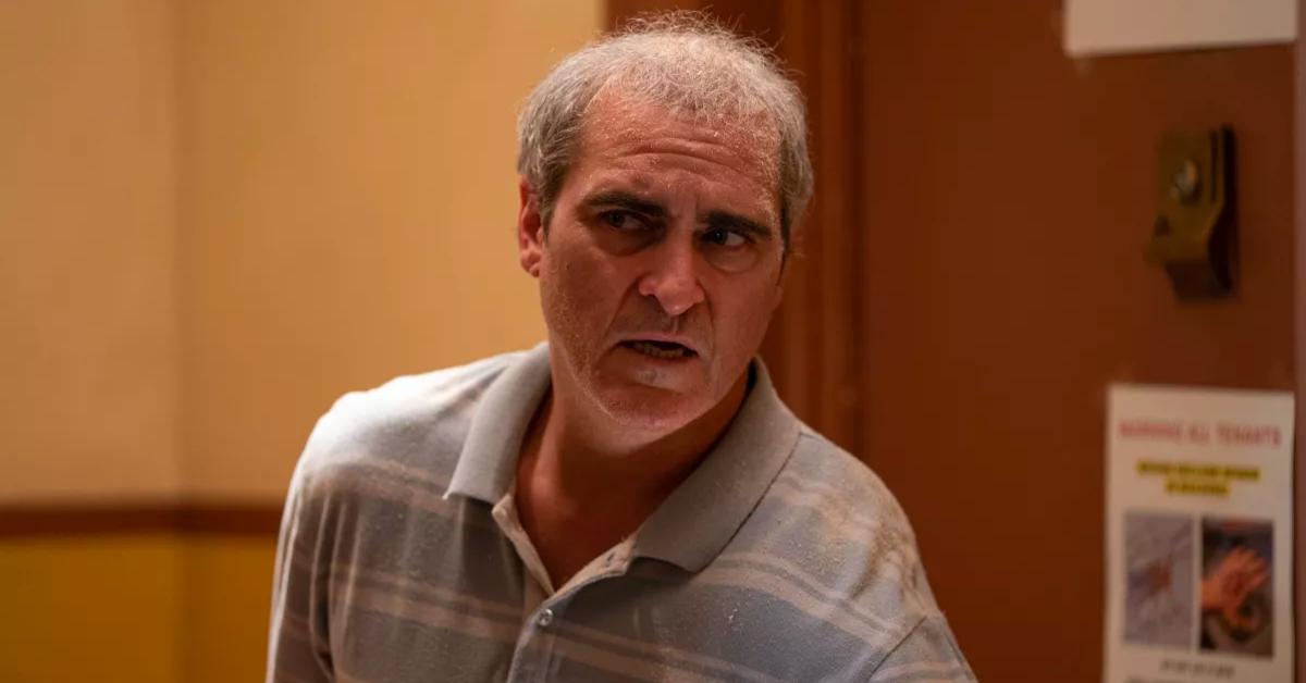 Beau (Joaquin Phoenix) nervously looks around the corner in 'Beau Is Afraid'