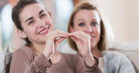 teenage girl with mother using sign language picture id