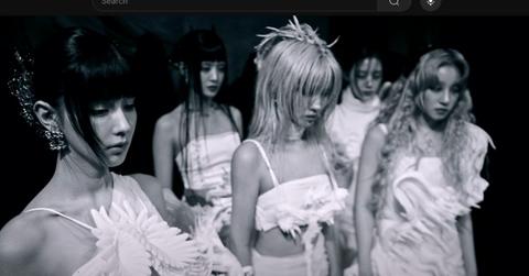 I-DLE in a video in black and white.