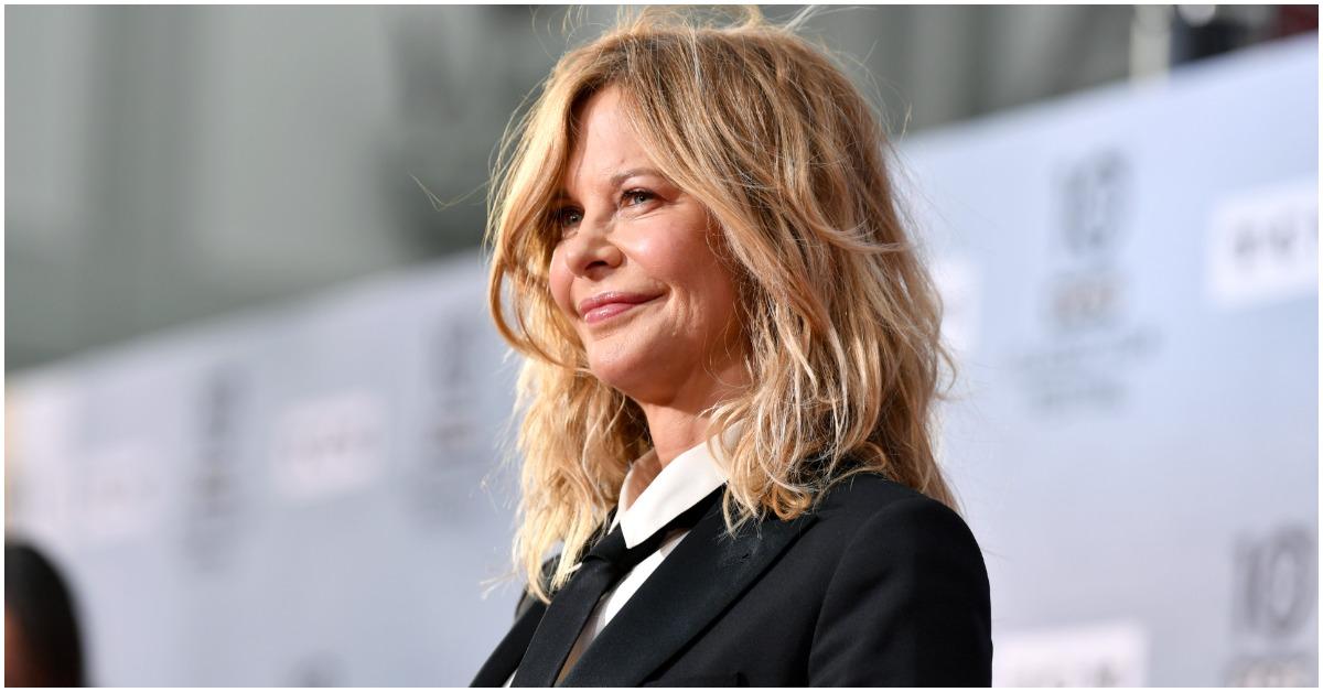 Meg Ryan smiling while attending a red carpet event.