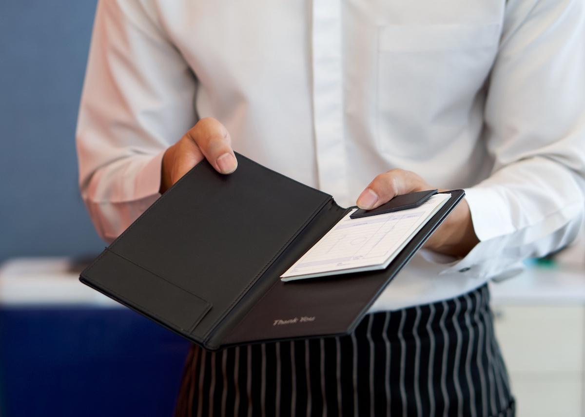 A waiter presenting a bill