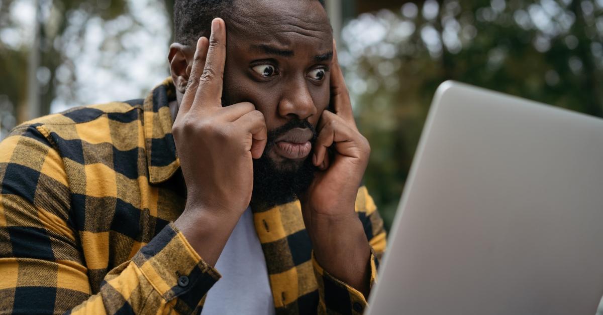 A frustrated man on a computer.