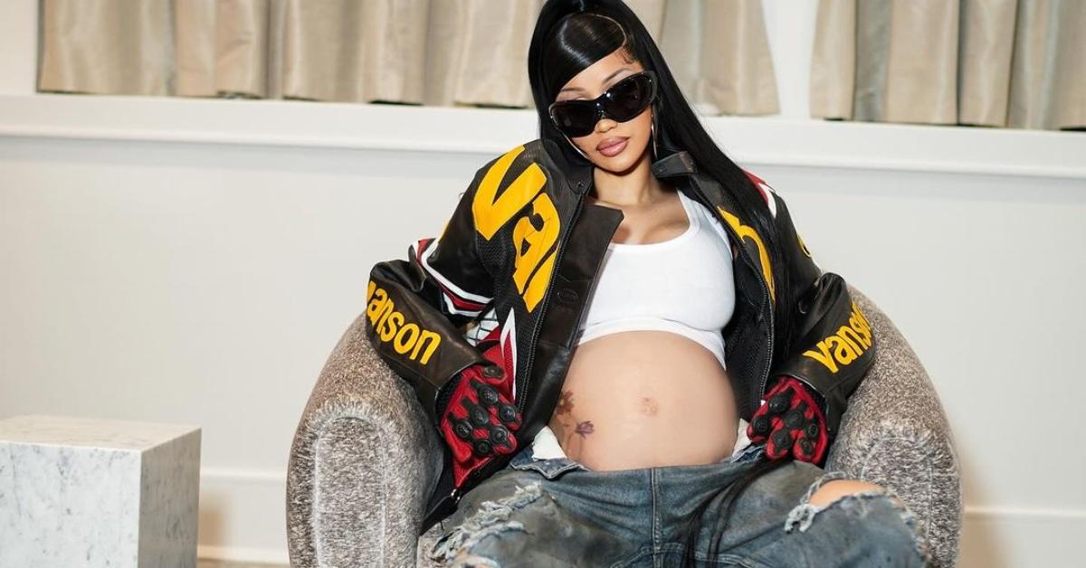 Cardi B sits in a chair while pregnant