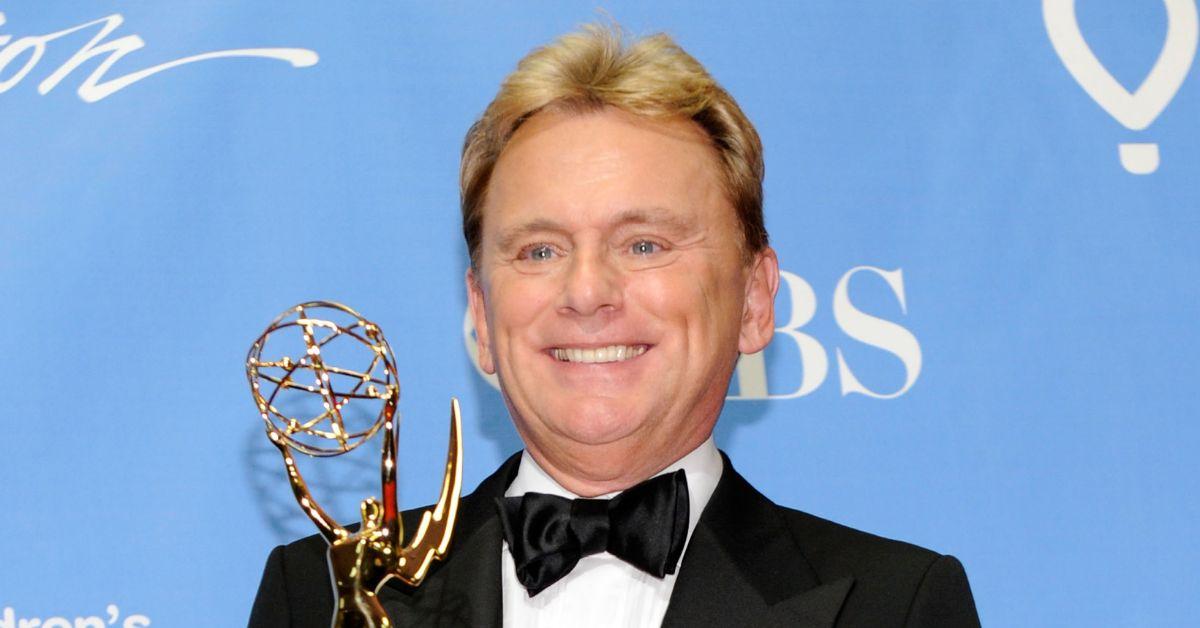 Pat Sajak holding a Daytime Emmy and smiling.