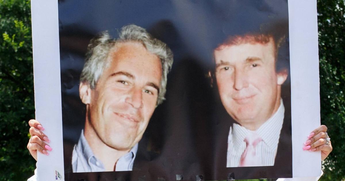 A protestor carries a photo of Jeffrey Epstein with Donald Trump