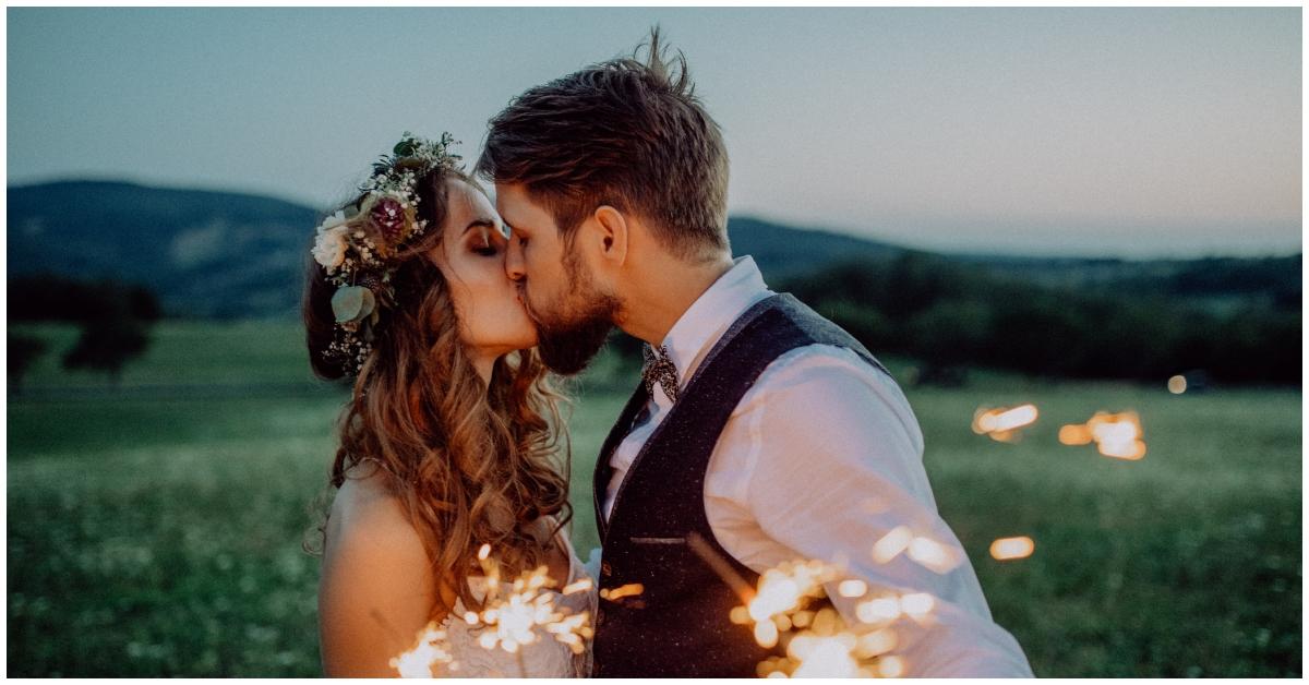 A couple kissing on her wedding day