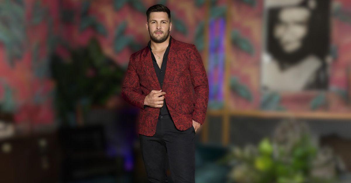 Brock Davies's reunion look is a dark red jacket and black pants