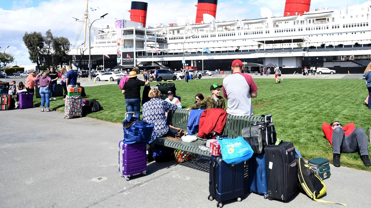 Passengers wait to board a Carnival cruise ship on March 7, 2020.