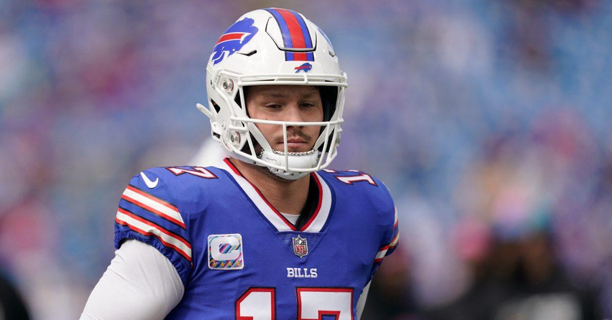 Josh Allen running on the field in his Buffalo Bills uniform.