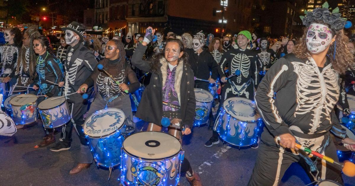 Kids dressed up playing drums