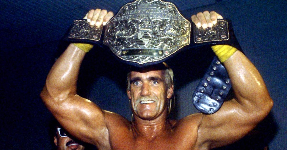 Hulk Hogan holding up a wrestling belt in 1994.
