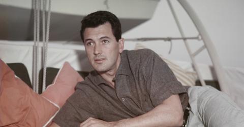 Rock Hudson lounging and reading a book in 1955