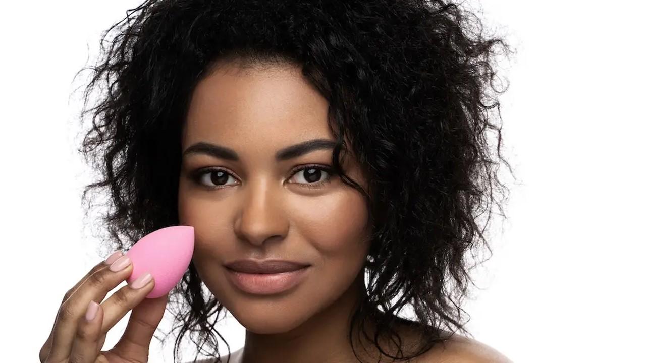 A woman holding a makeup sponge