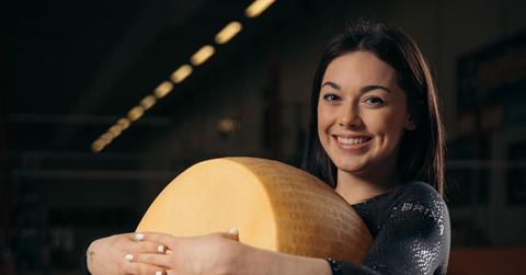 Giorgia Villa holding a big wheel of parmesan