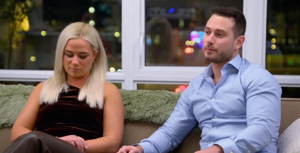 Emily and Brennan sit on a couch together on MAFS