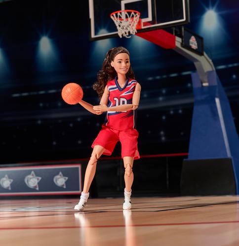 Sue Bird's Barbie role model doll playing basketball on the court.