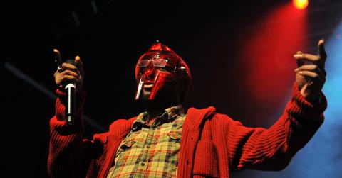 MF Doom performing on stage in a red mask.