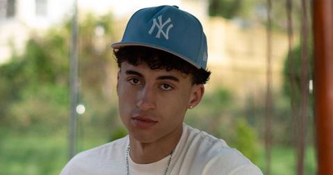 Isaac Francis in a yankee hat and a white t-shirt.