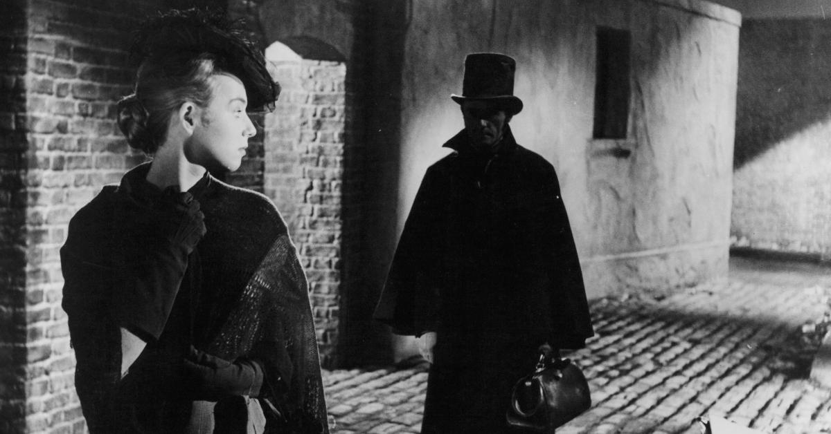 Unknown actress looking back at a man following her in a scene from the film 'Jack The Ripper', 1959.