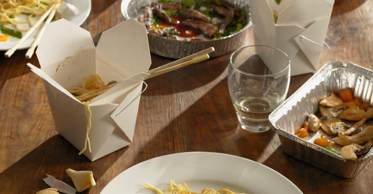 Half-eaten Chinese takeout dinner - stock photo