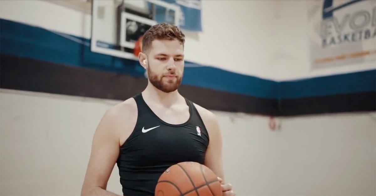 Hunter Dickinson in a gym holding a basketball.