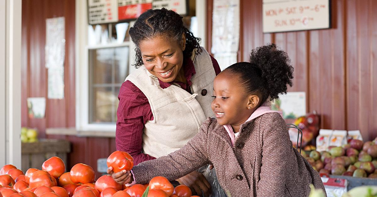 Woman and girl picking tomatoes