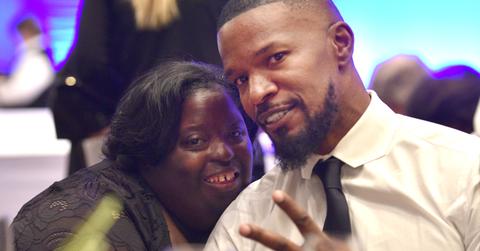 Jamie Foxx flashes a peace sign while posing with DeOndra.