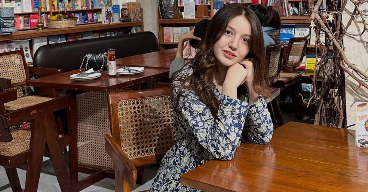 Sana Yousaf at a table in a restaurant