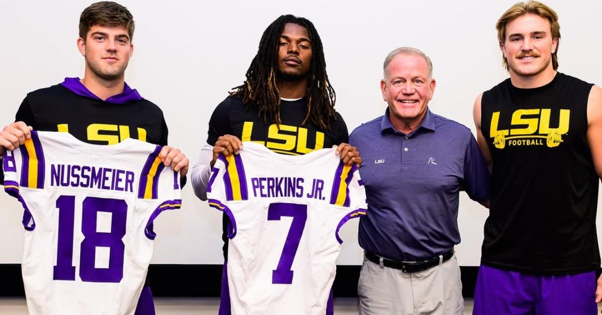 Brian Kelly with three LSU players.