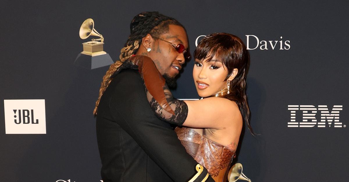 Offset looks at Cardi B. seductively and Cardi B smiles on the red carpet.