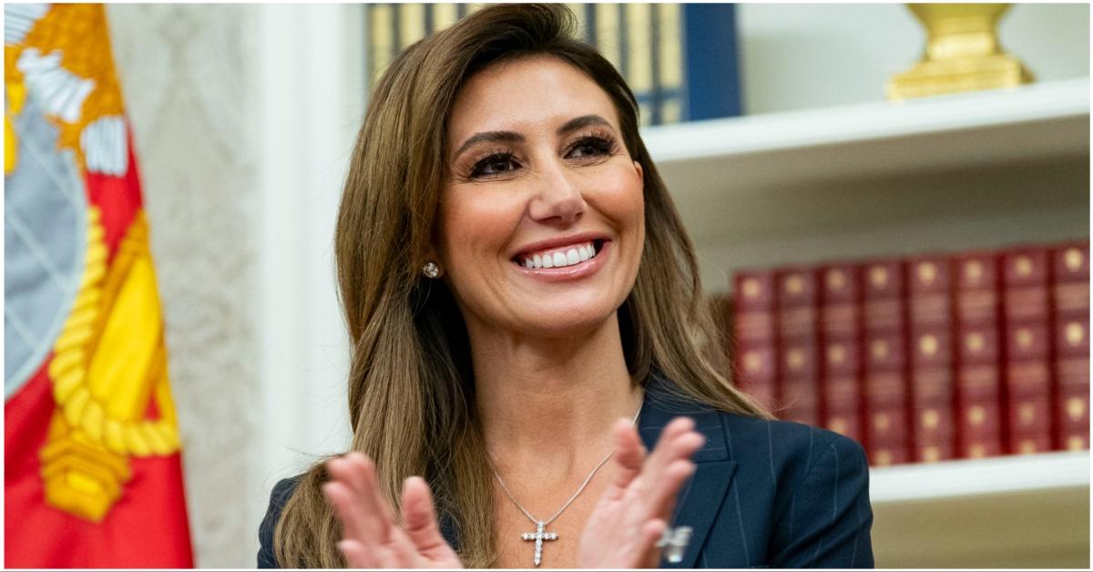 Alina Habba smiling and applauding 