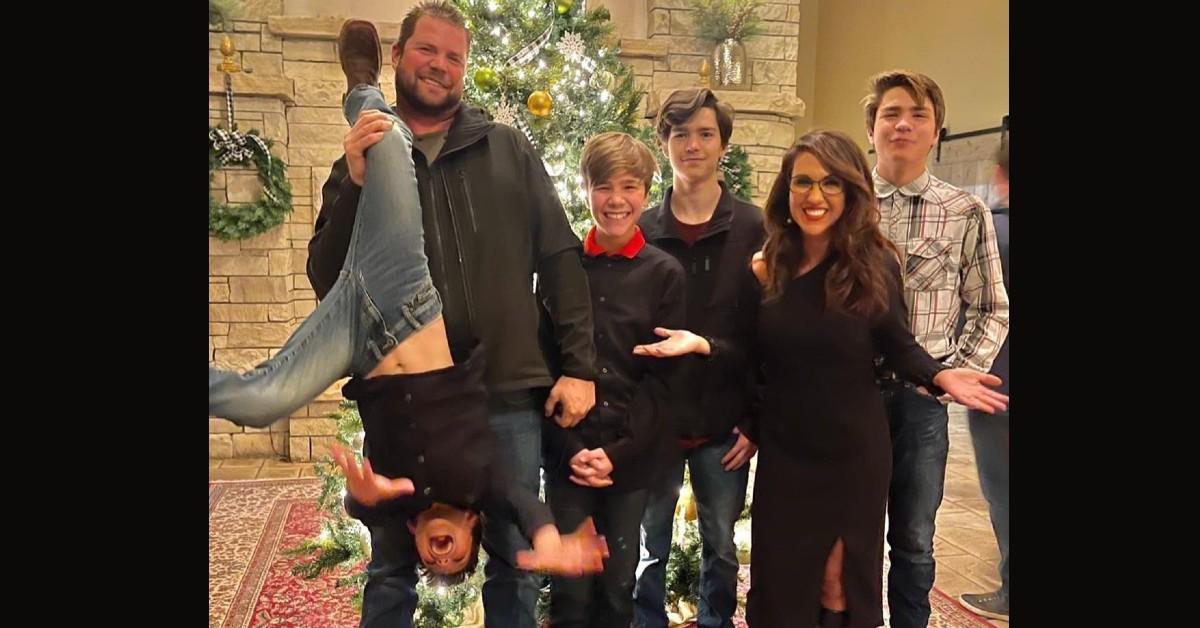 Jayson Boebert and Lauren Boebert pose in front of a Christmas tree with their four sons