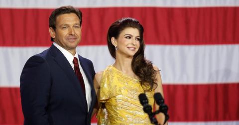 Ron and Casey DeSantis standing at a podium together.
