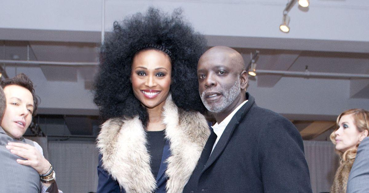 (l-r): Cynthia Bailey and Peter Thomas smiling and posing at an event.