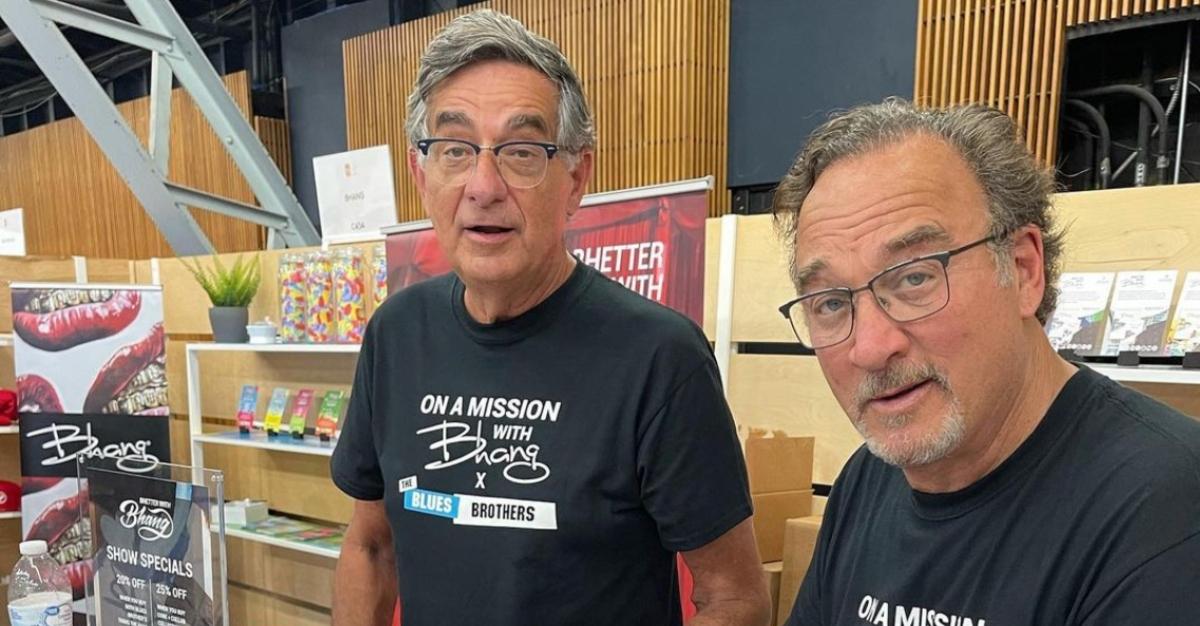 Chris Karakosta and cousin Jim Belushi signing autographs together in 2021