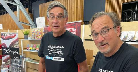 Chris Karakosta and cousin Jim Belushi signing autographs together in 2021