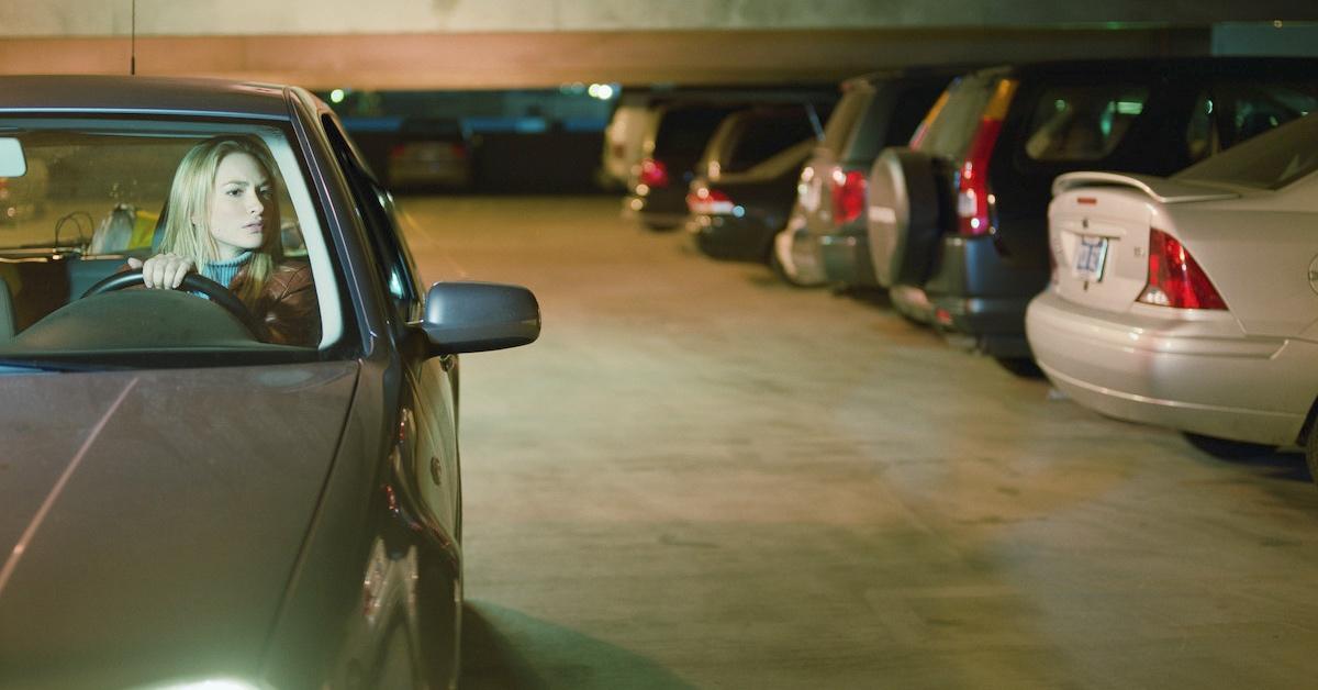 A woman driving in a parking garage