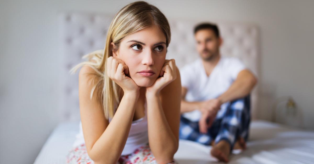 A husband and wife arguing in their bedroom.