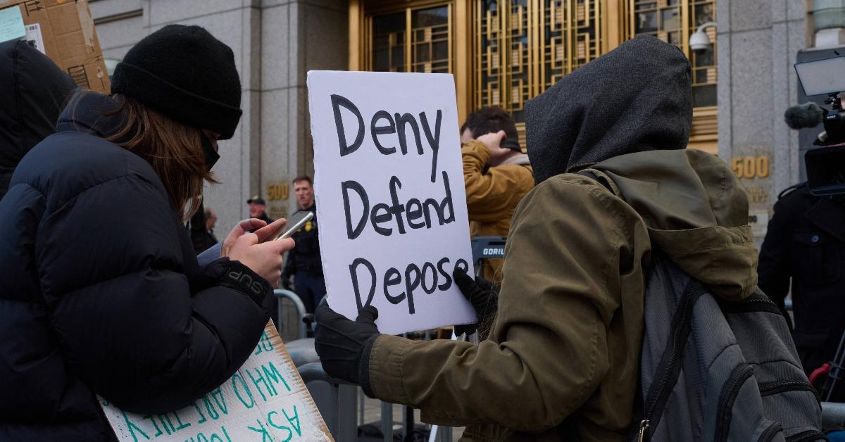 Protestors outside of the courthouse where Luigi Mangione was arraigned