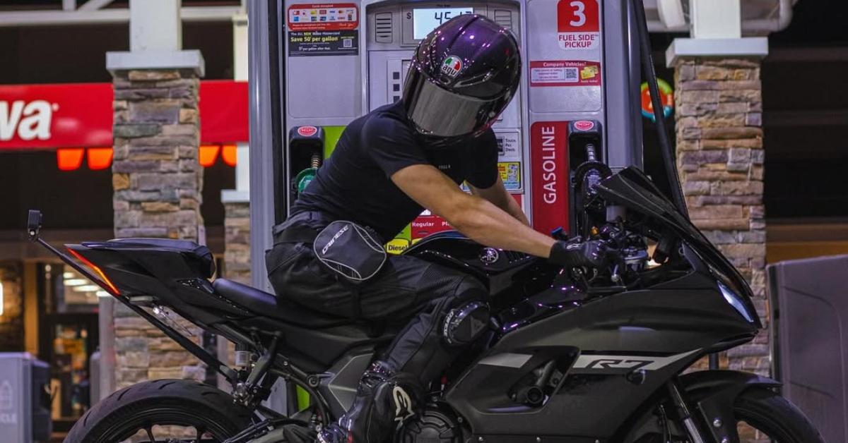 DancingMoto on his bike at a gas station.